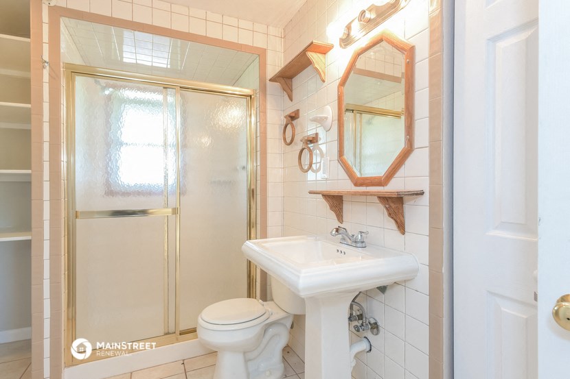 a bathroom with a sink and a shower and a toilet