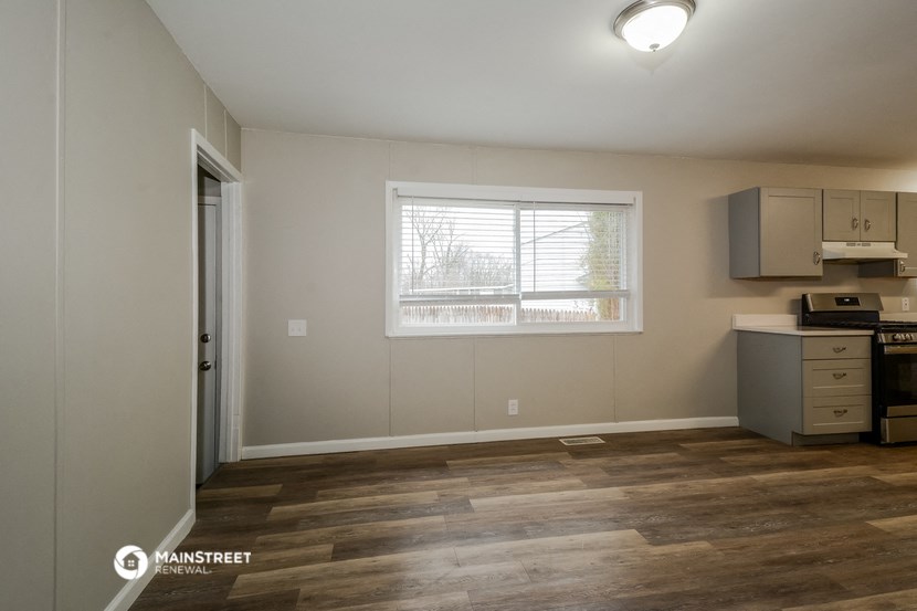 an empty kitchen with a sink and a window