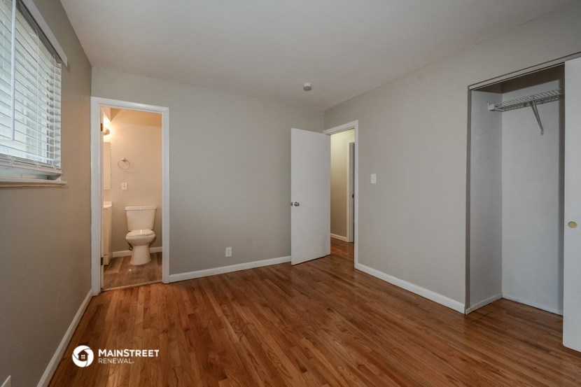 a bedroom with a toilet and a door to a bathroom