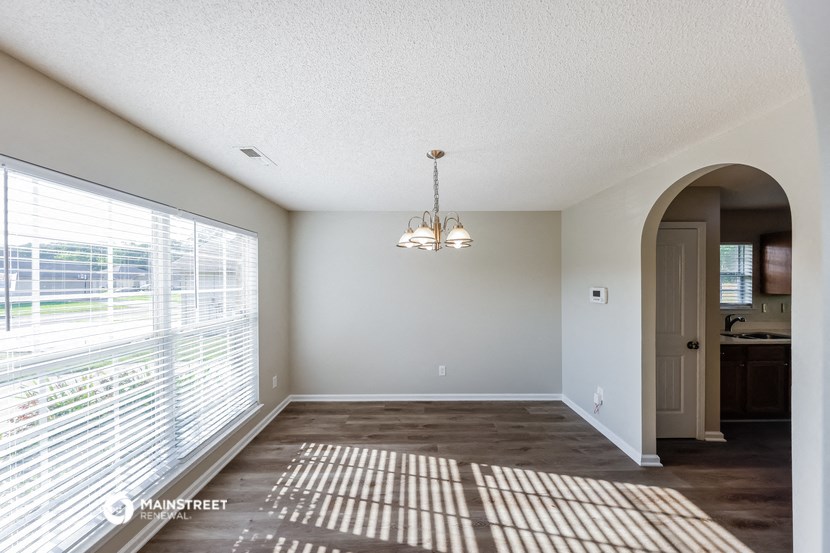 an empty living room with a large window