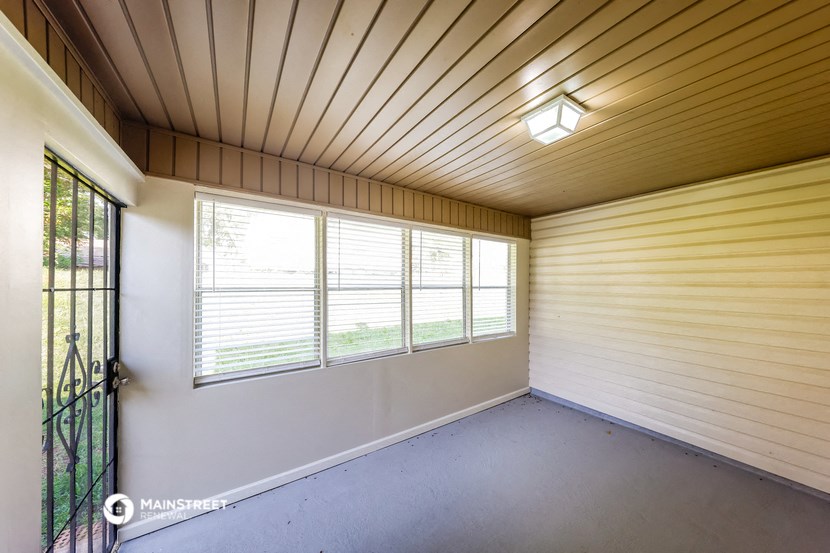 a room with a large window and a door