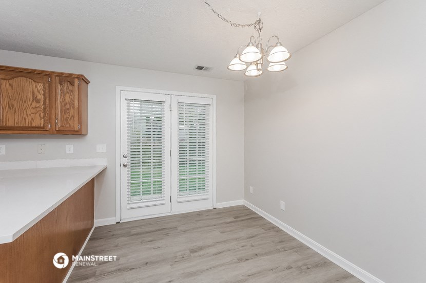 the living room and dining room of an apartment