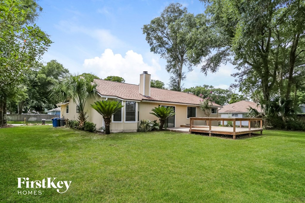 a backyard with a deck and a house