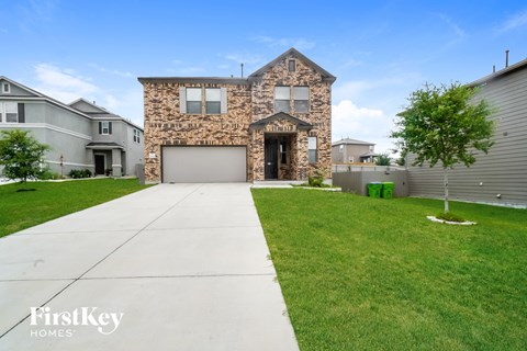 a stone house with a sidewalk in front of it