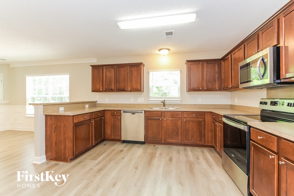 a kitchen with wooden cabinets and a white counter top