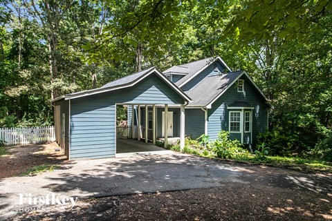 a blue house with a garage with a driveway