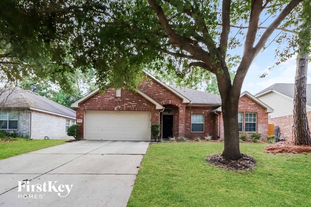 A house with a tree in front of it.