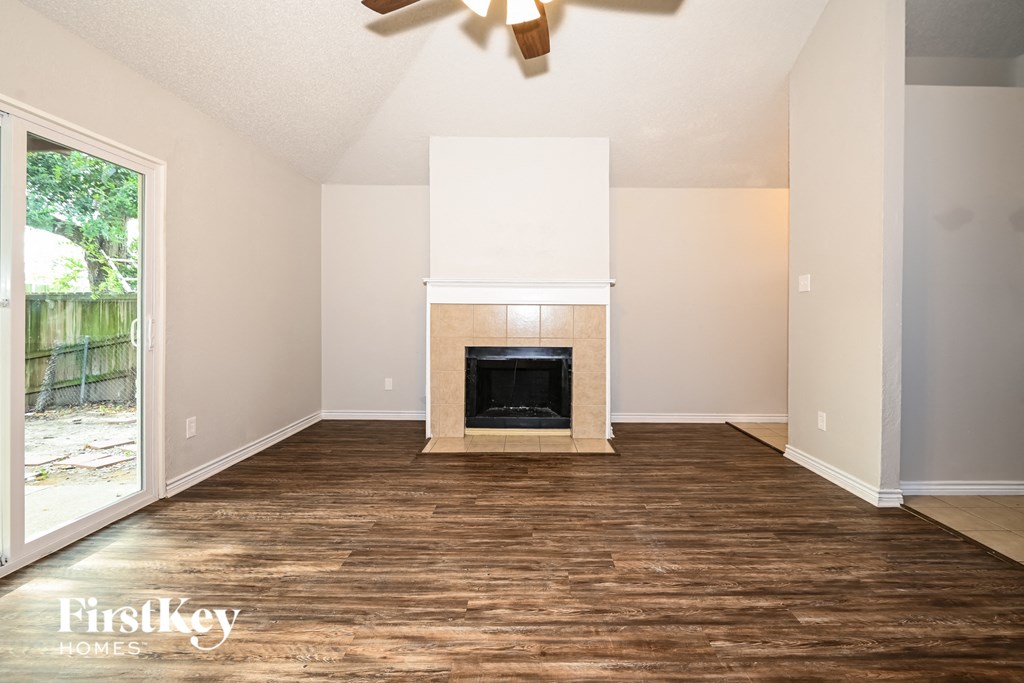 a living room with wood flooring and a fireplace