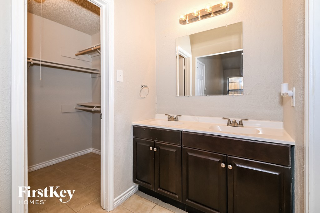 a bathroom with a sink and a mirror and a shower