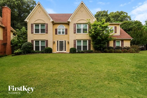 a house with a large lawn in front of it