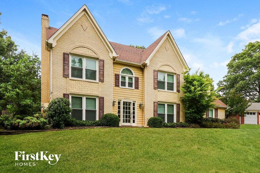 a house with a green lawn in front of it