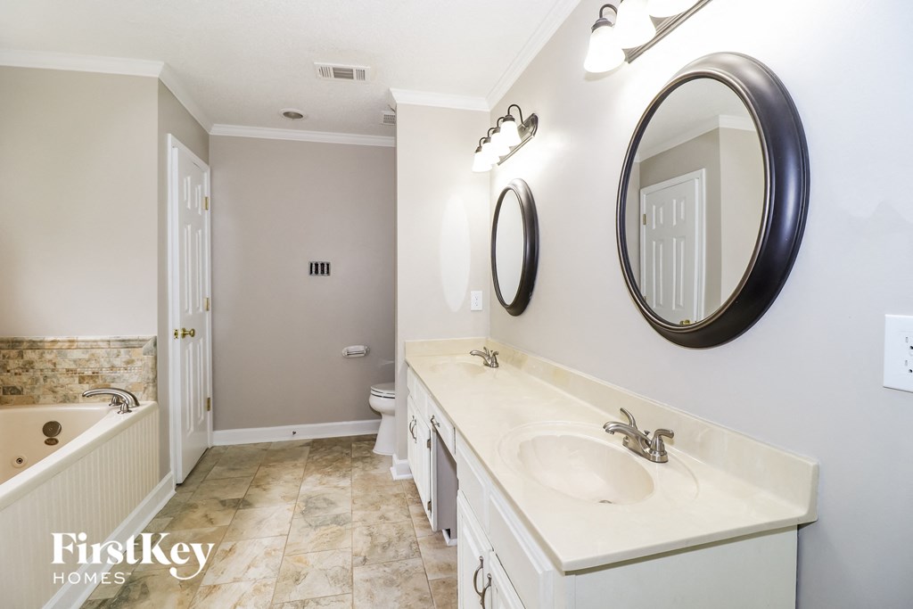 a bathroom with a sink and a tub and a mirror