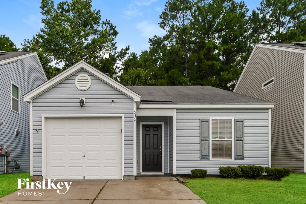 A two-story house with a garage is for sale.