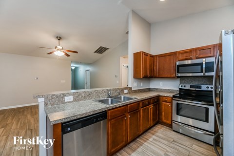 A kitchen with wooden cabinets and stainless steel appliances.
