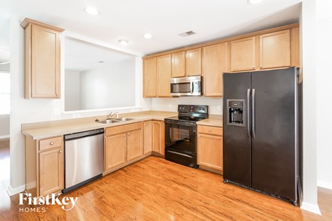 a kitchen with wooden cabinets and stainless steel appliances