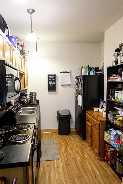 a small kitchen with a stove and a refrigerator