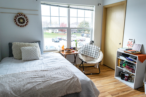 a small bedroom with a bed and a window