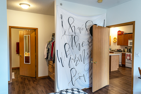 a bedroom with a closet and a white wall with writing on it