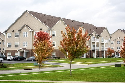 an apartment building with trees in front of it