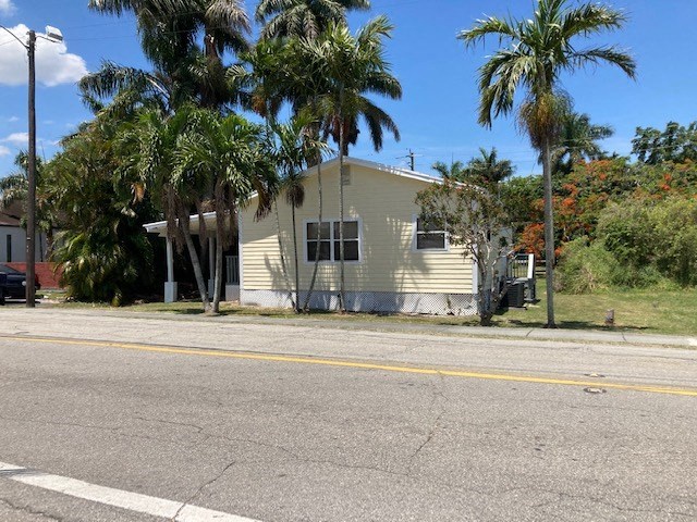 A house with a fence and a car parked in front.