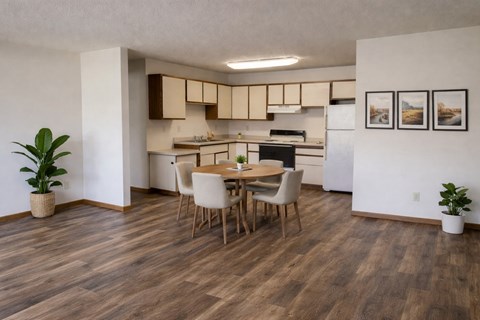 A kitchen with a dining table and chairs.