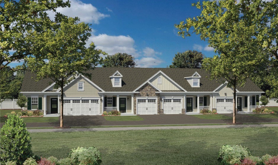 a house with white garage doors and a grass yard