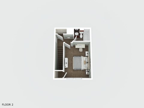 A floor plan of a room with a bed, a desk, and a chair.