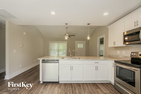 A kitchen with white cabinets and a stainless steel oven.