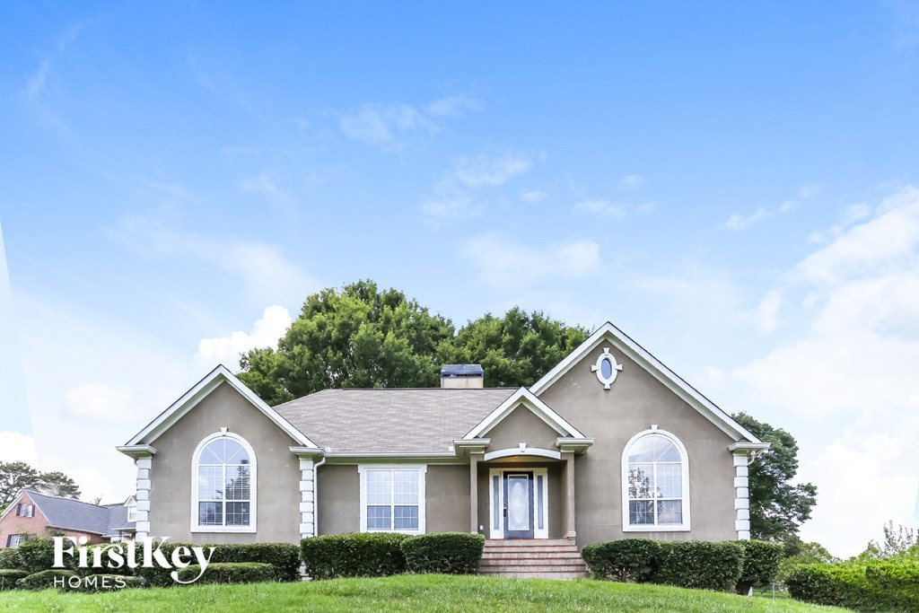 a house with a lawn and a blue sky