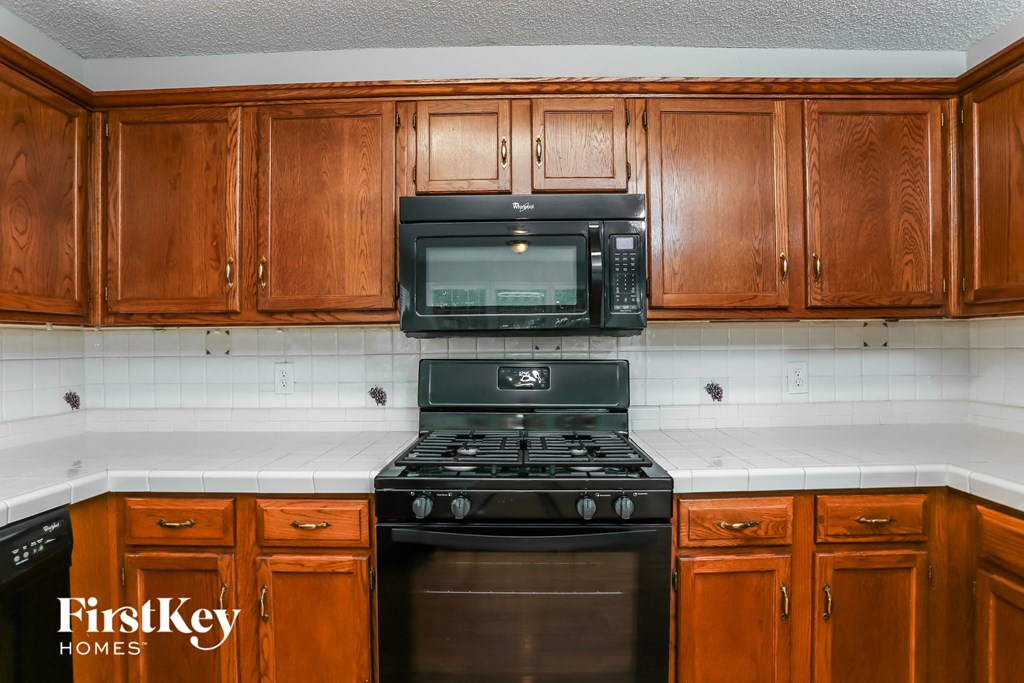 a kitchen with a stove and a microwave