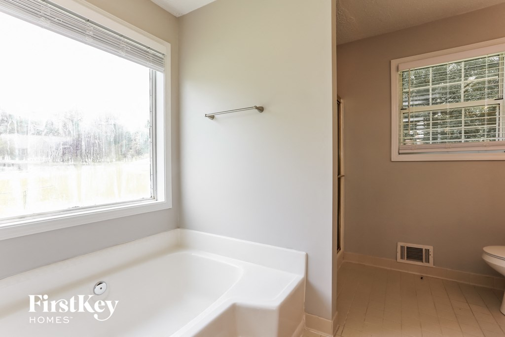 a bathroom with a large tub and a window