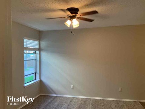 a bedroom with a ceiling fan and a window