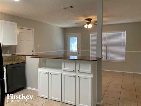 a kitchen with white cabinets and a counter top