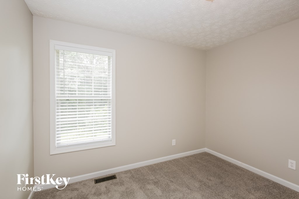 a room with a carpeted floor and a window