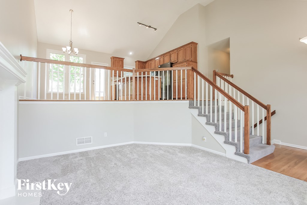 the family room is open to the great room and stairs to the 2nd floor