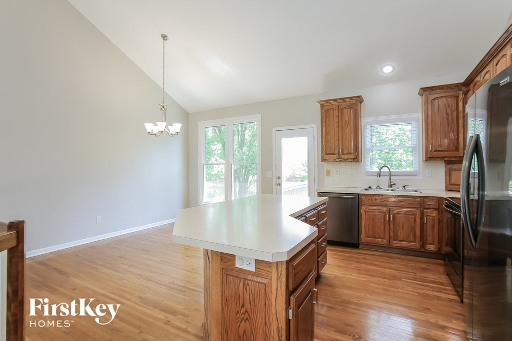 a kitchen with wooden cabinets and a white counter top
