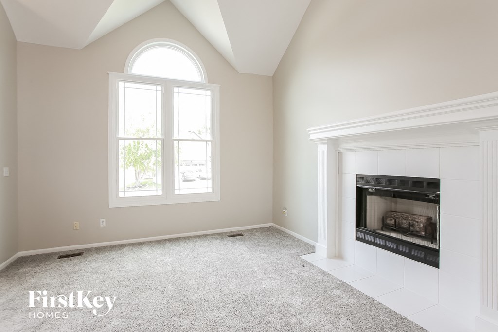 a living room with a fireplace and a window
