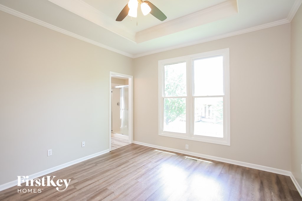 a living room with a wood floor and a ceiling fan