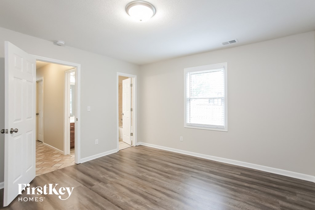 a living room with a hard wood floor and a white door