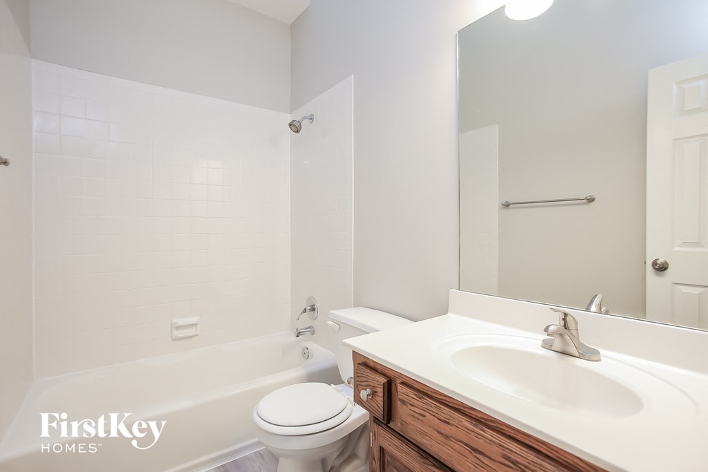a bathroom with a sink toilet and bath tub