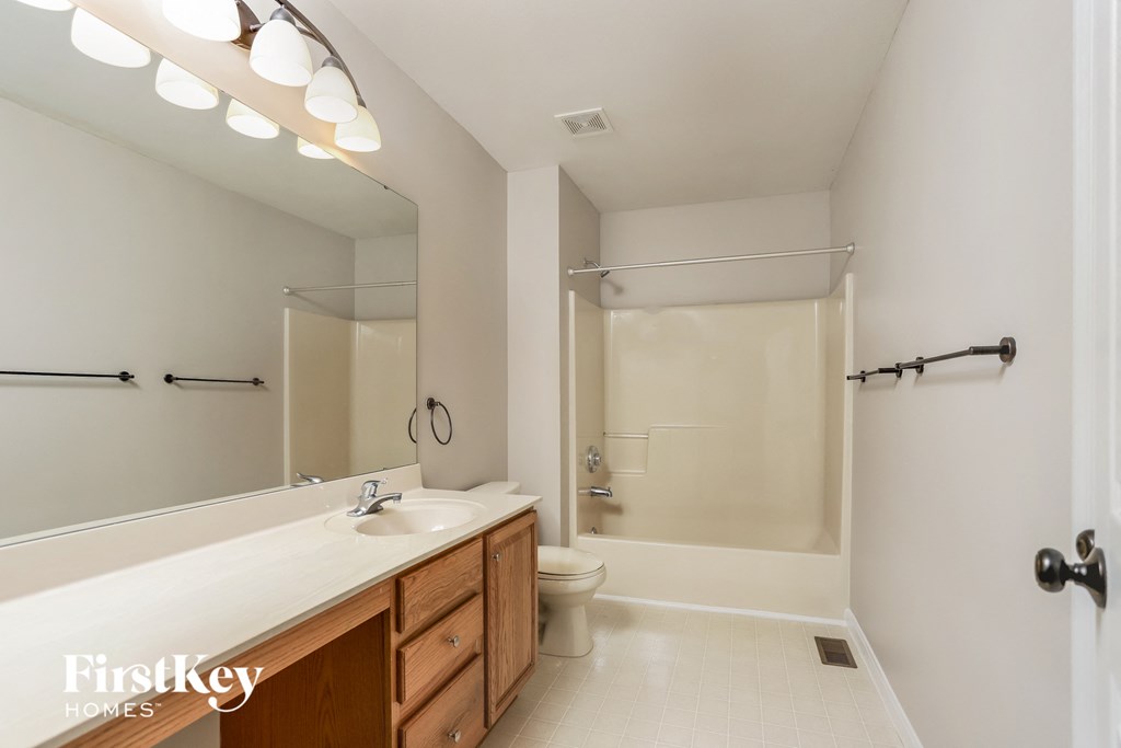 a bathroom with a sink and a toilet and a shower