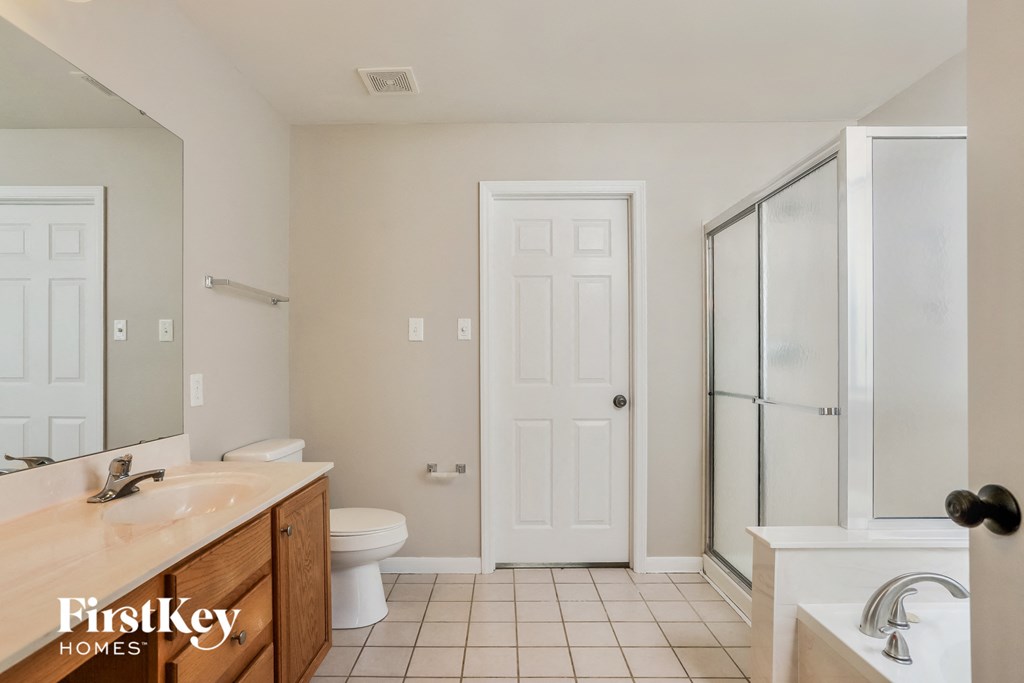 a bathroom with a toilet and a sink and a shower