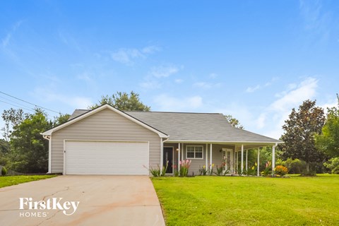a house with a lawn and a driveway