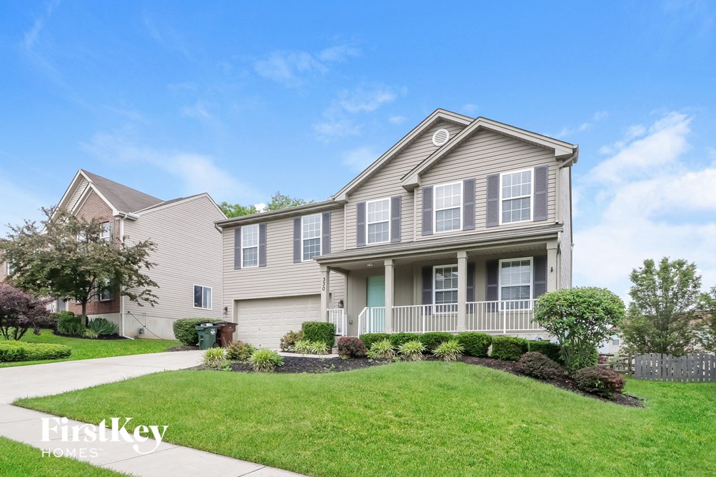 a house with a lawn and a sidewalk in front of it