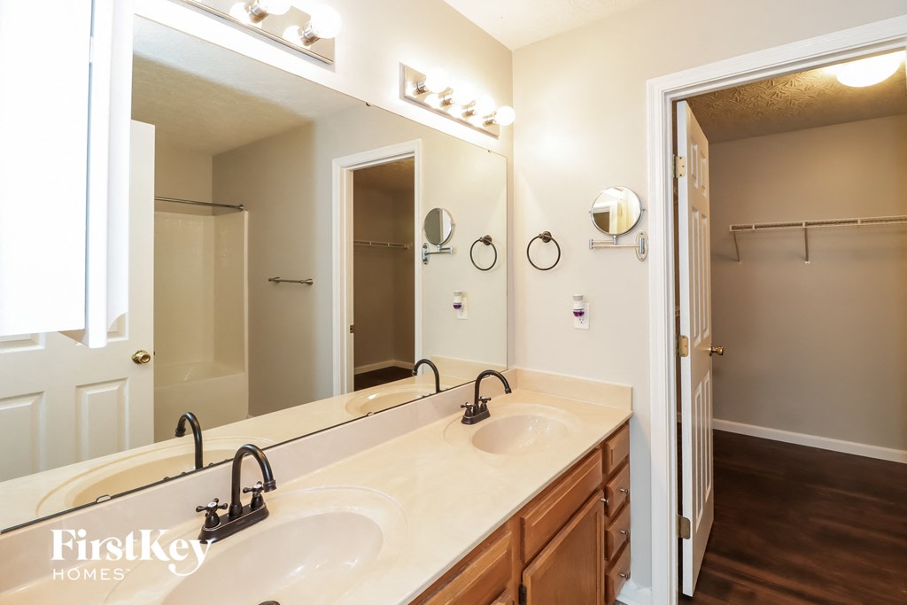 a bathroom with two sinks and a large mirror