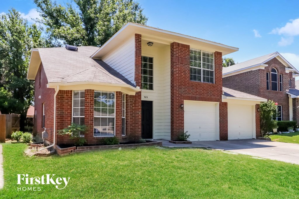 A brick house with a garage is for sale.