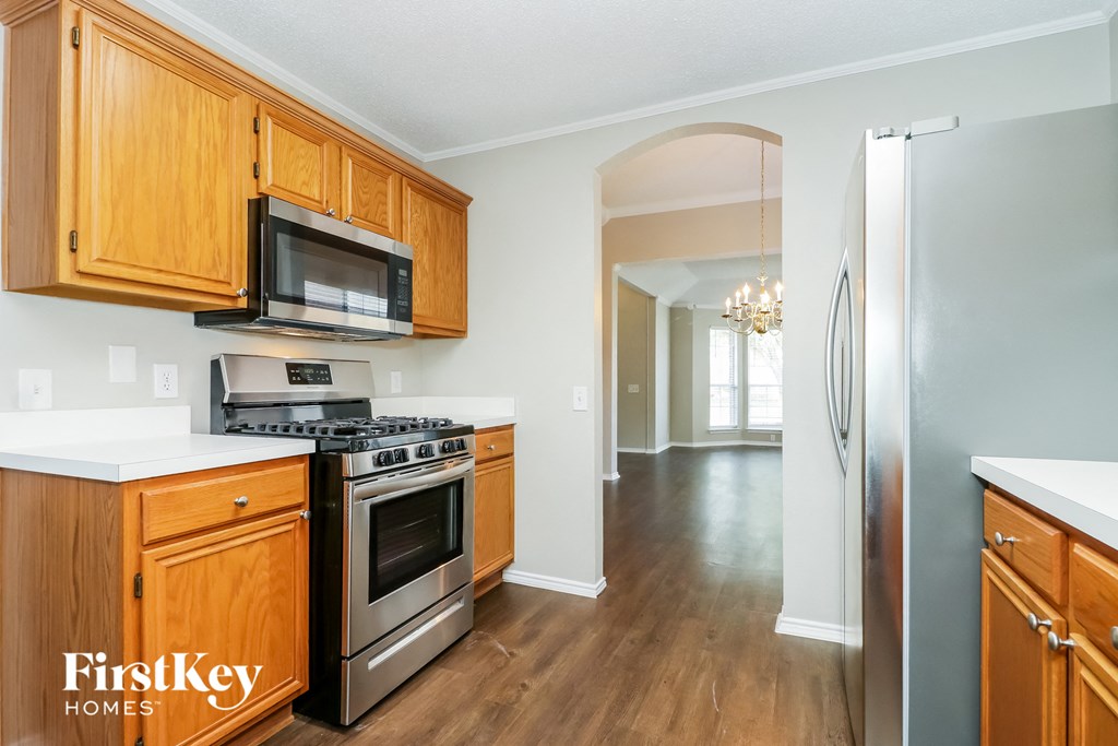 A kitchen with wooden cabinets and stainless steel appliances.