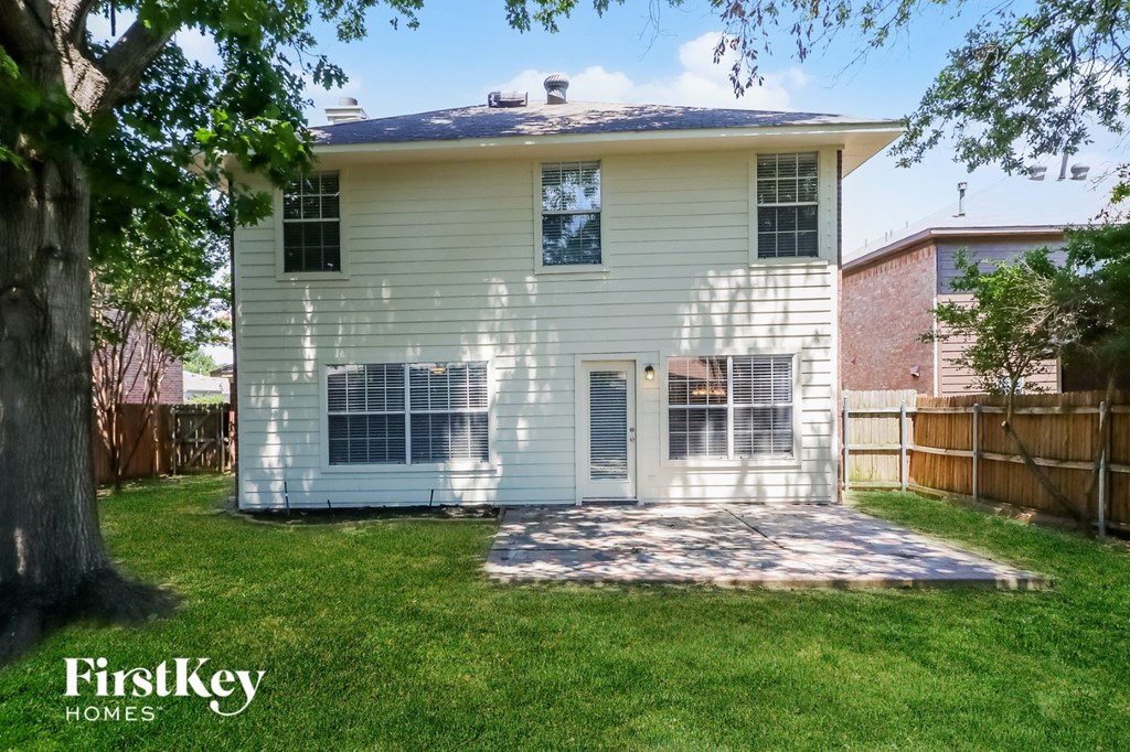 A house with a white siding and a brown roof is for sale.