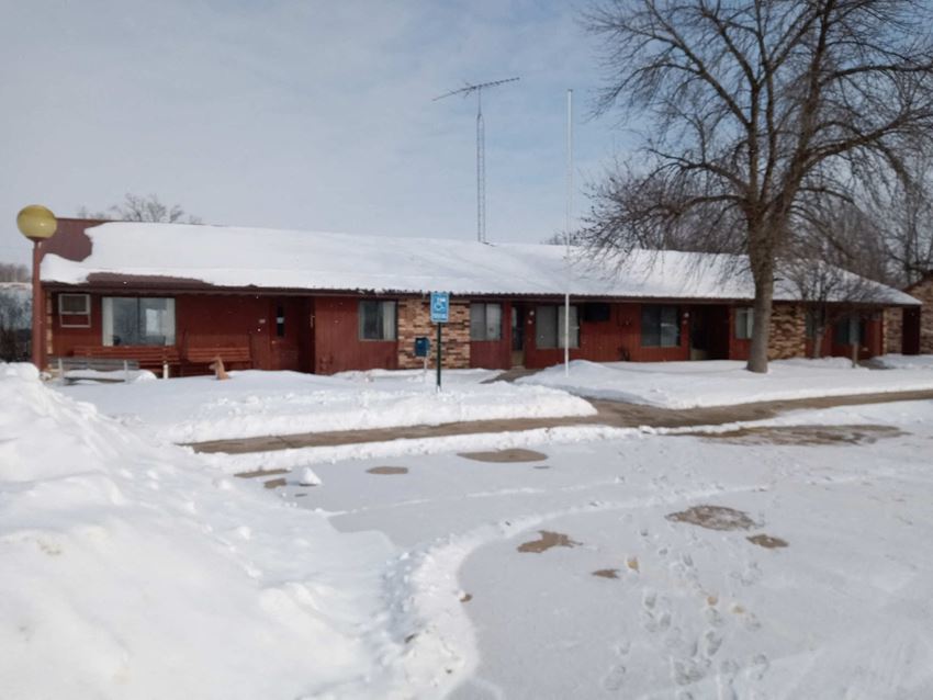 a red motel with snow on the roof