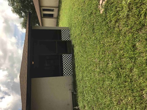 a view from above of a building with a grassy yard